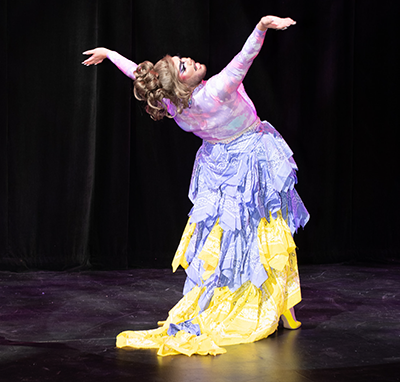 Actor on stage in extravagant costume at the DRAG ON EXTRAVAGANZA