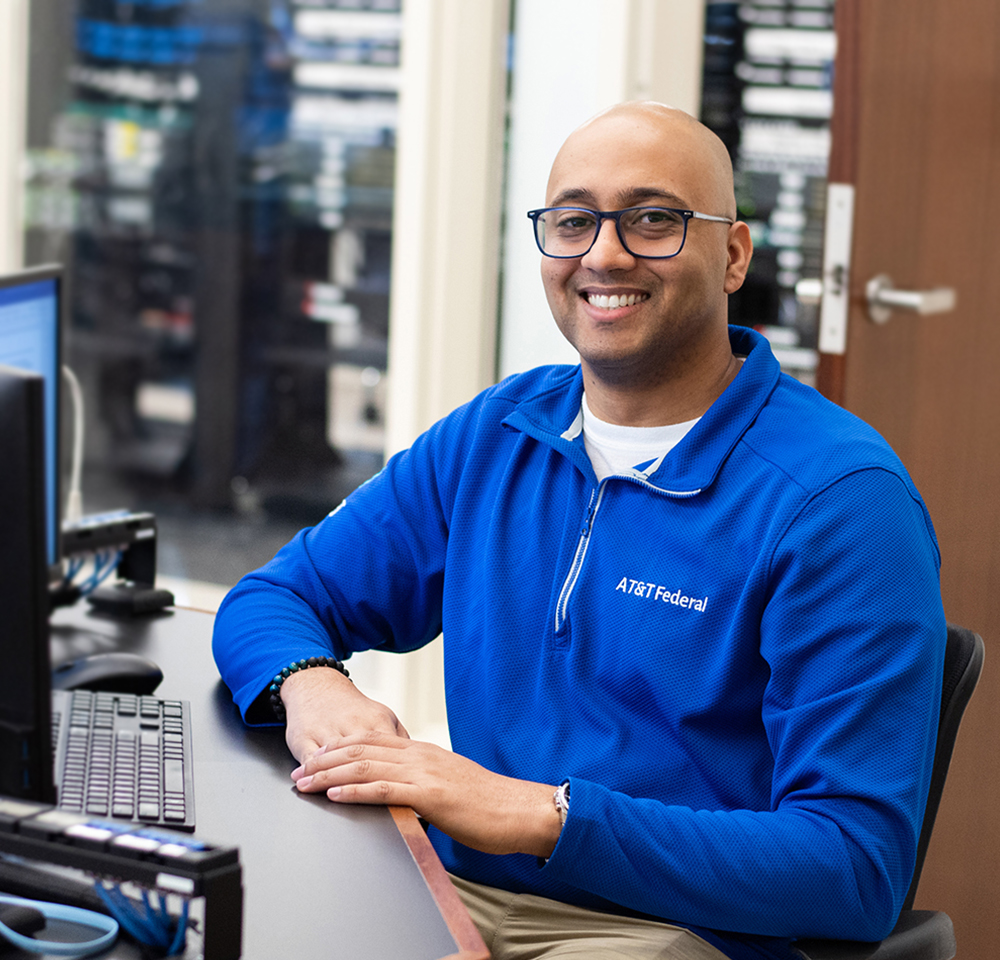 Headshot of Anderson Jaggernauth sitting in an IT lab.
