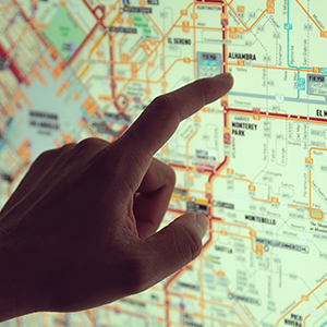 photo of a finger pointing to a map
