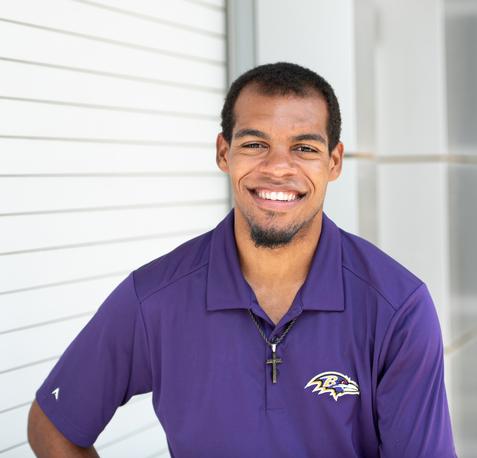 Photo of Xavier, wearing Ravens shirt, smiling
