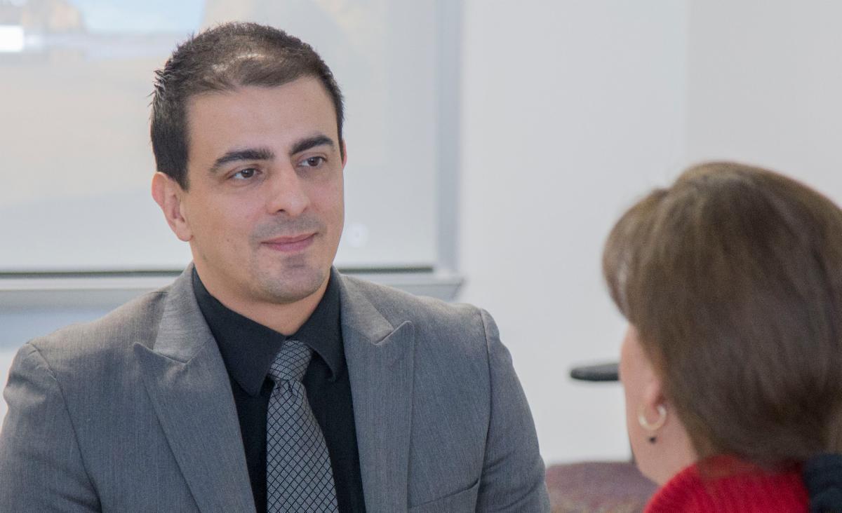 Man in tie talking with teacher