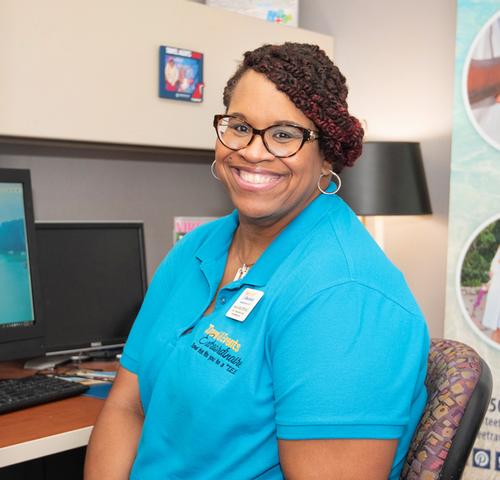 Photo of Anne Smith sitting at her desk
