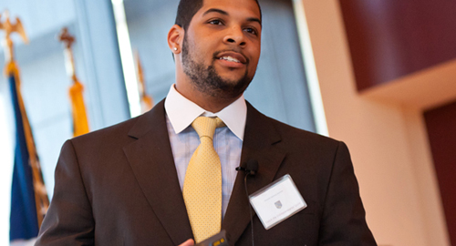 Man in suit at front of room