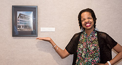 Woman standing next to photograph representing CORE program