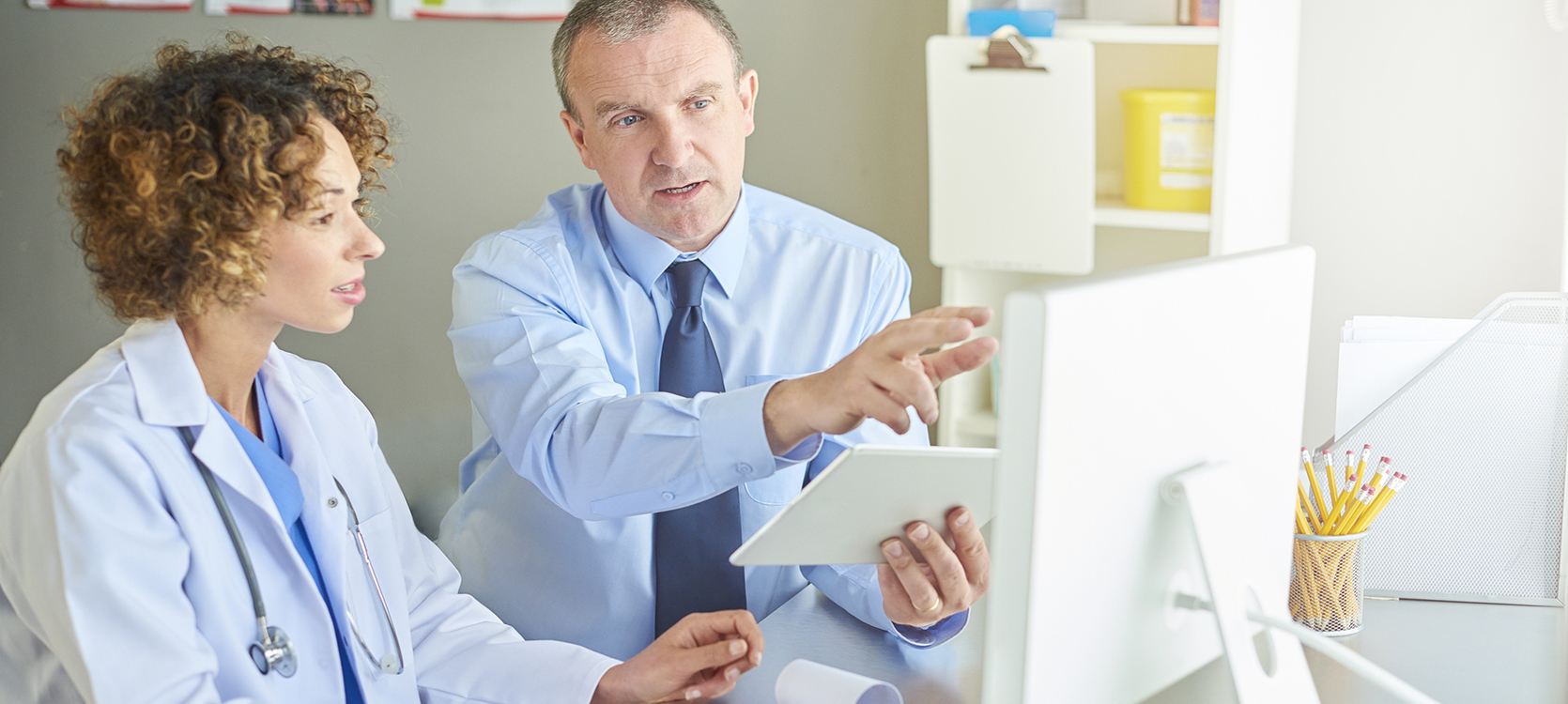 health professionals working together on a computer