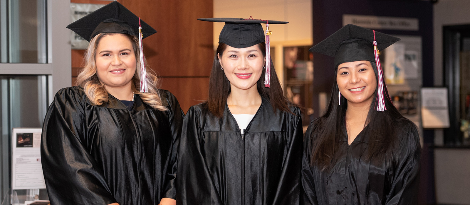 Three students graduating from the GED program.