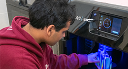 Student working on a 3D printer.