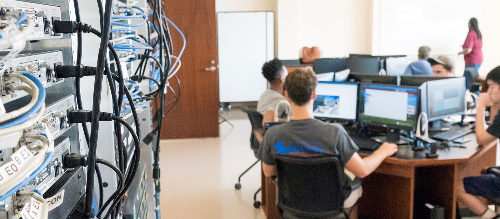 Students in a classroom with networking equipment