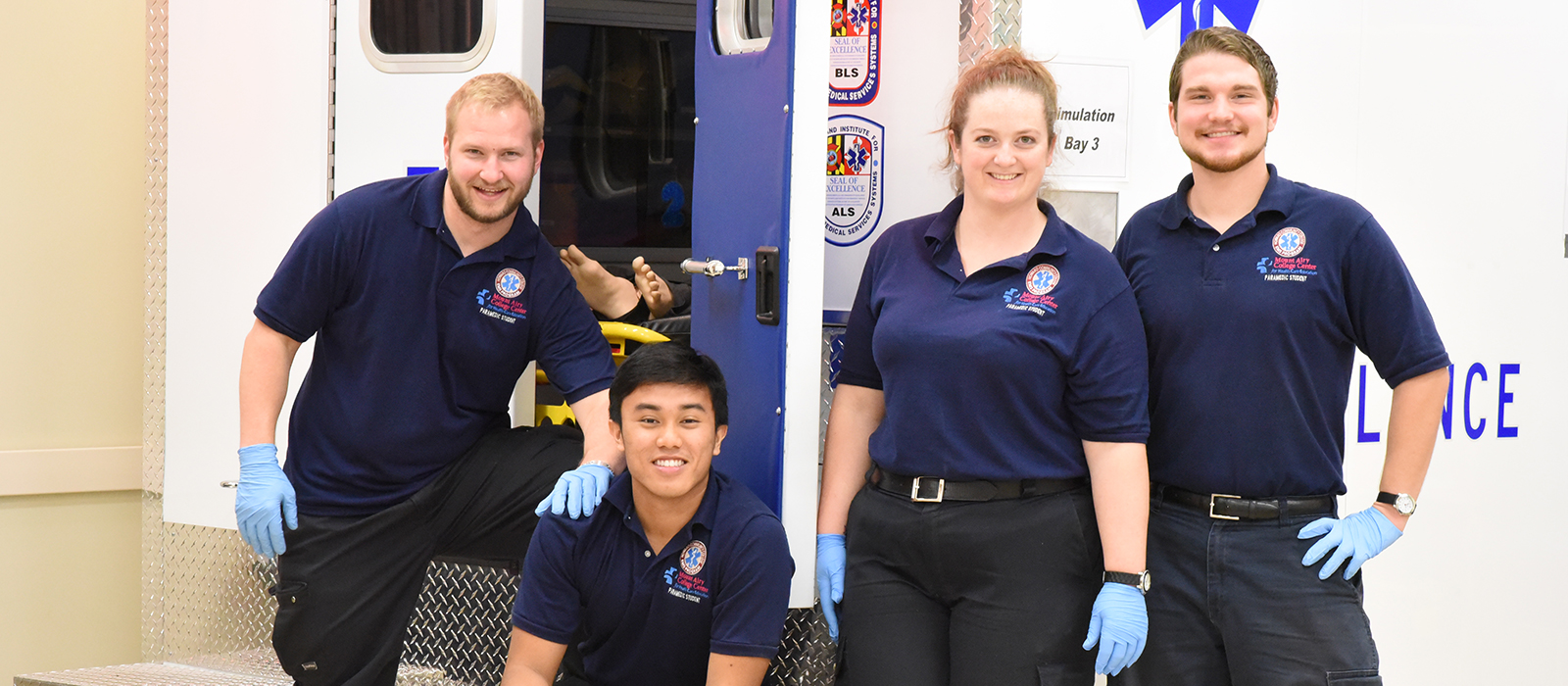 Four EMT/Paramedics at the back of an ambulance