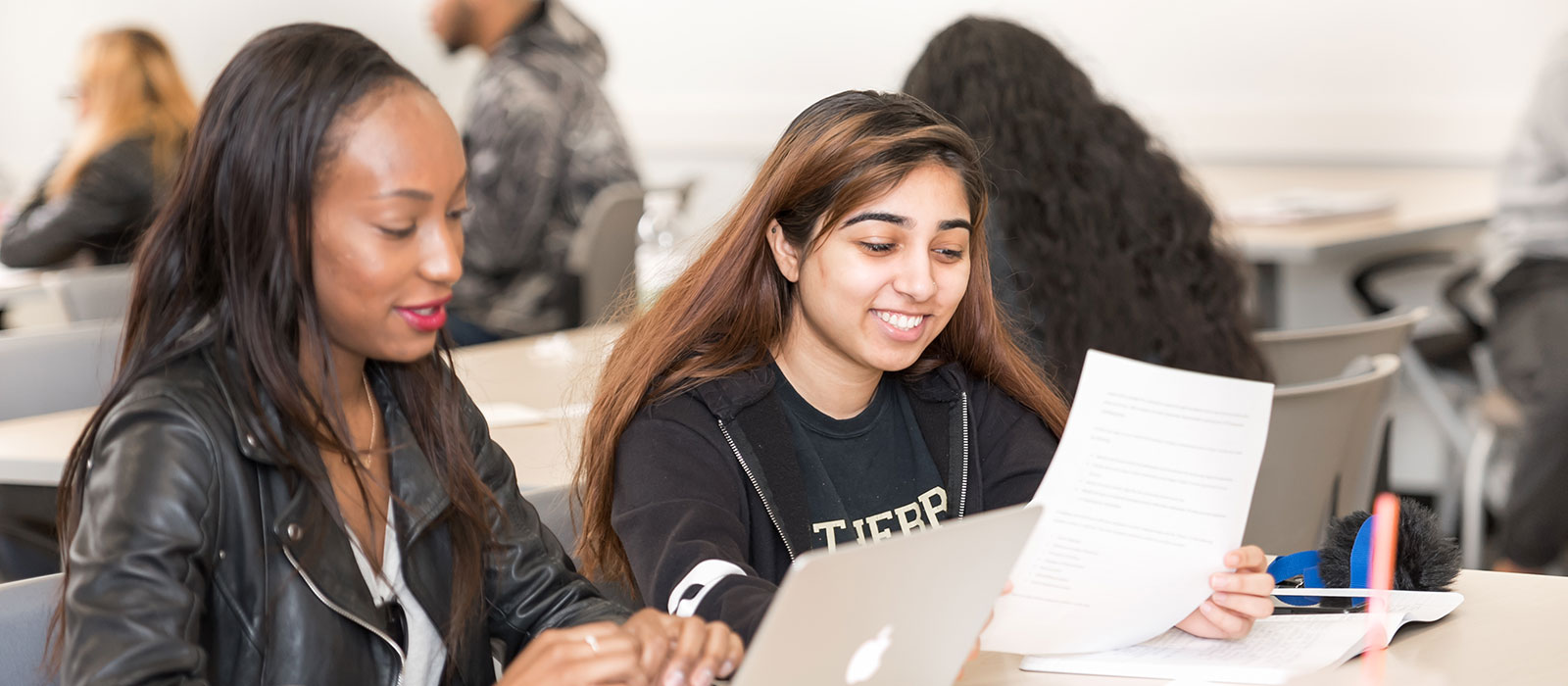 Two students sitting at a desk working