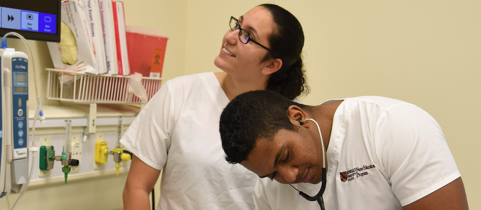 Two students in a white scrubs