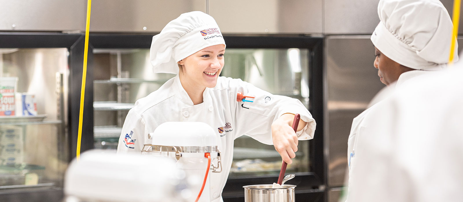 Two people wearing chef's clothing