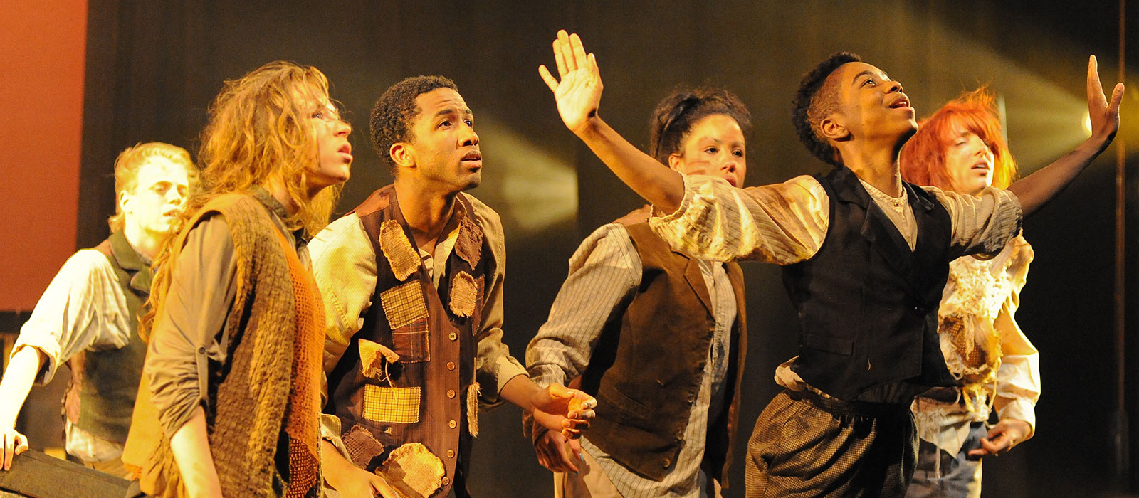 A group of performers in costume on stage