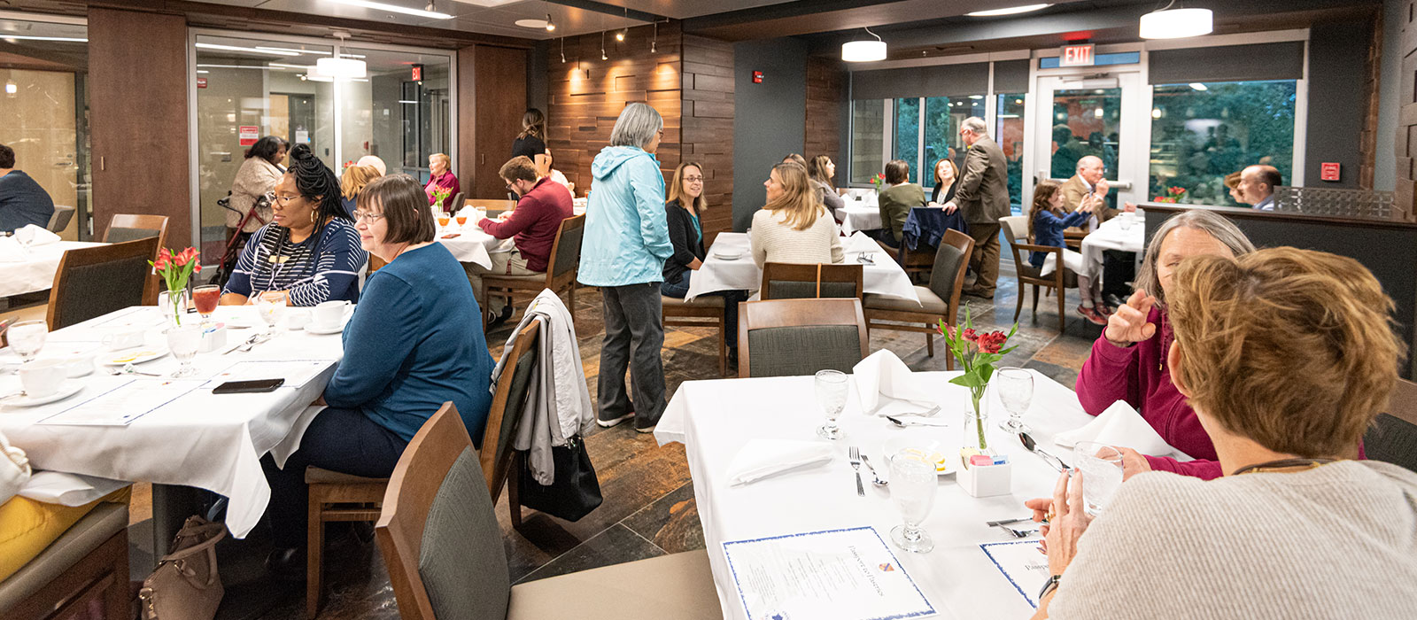 Patrons sitting at tables in a restaurant