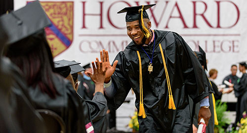 student graduating and receiving a high five